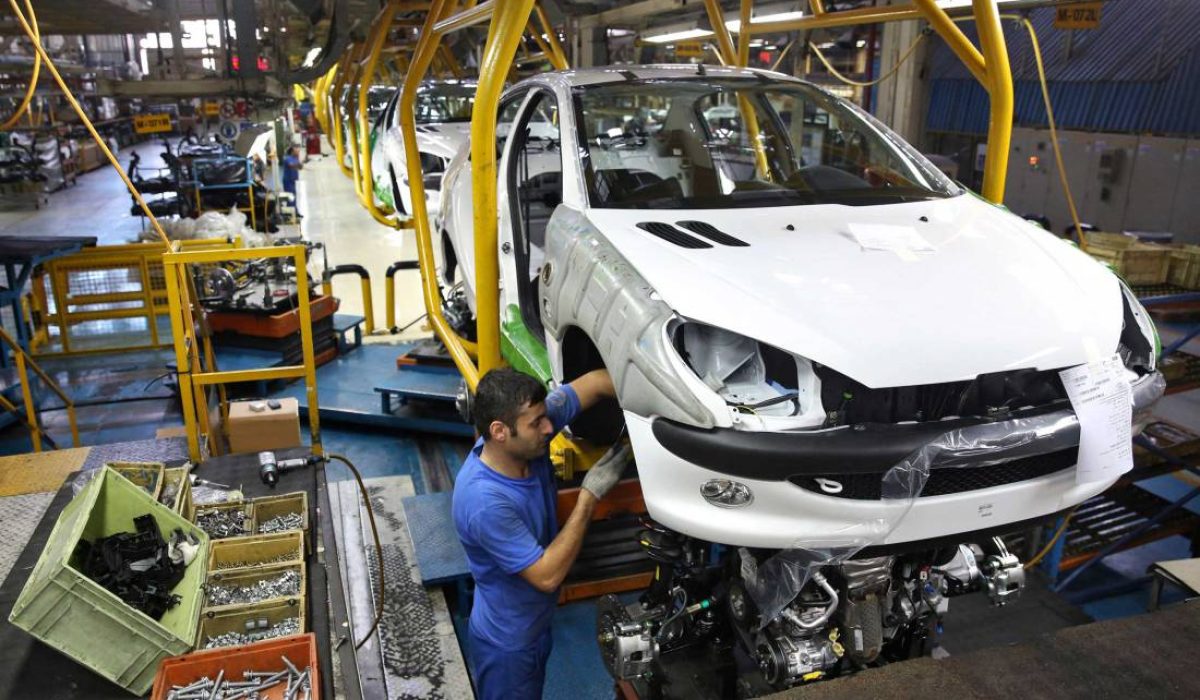 An Iranian worker assembles a Peugeot 206 at the state-run Iran-Khodro automobile manufacturing plant near Tehran, Iran, Saturday, Oct. 11, 2014. Iran-Khodro on Saturday inaugurated the production line of domestically built TU3 engine for Peugeot 206. (AP Photo/Ebrahim Noroozi)